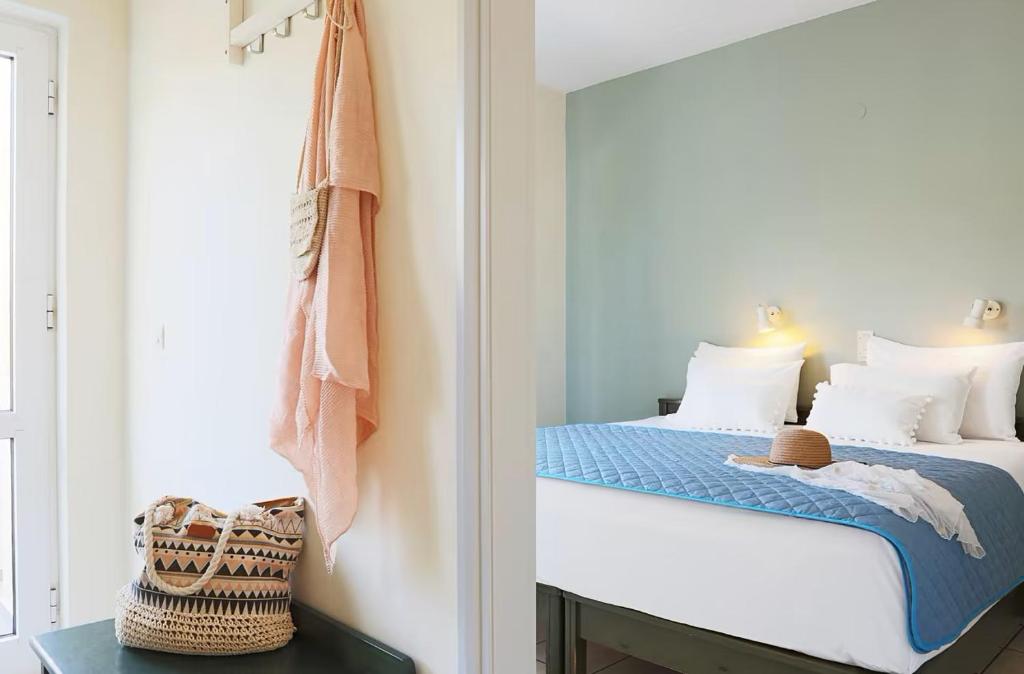 a small bedroom with a bed and a mirror at Mediterranea Apartments in Kato Daratso
