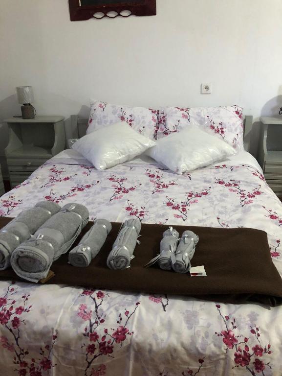a bed with a bunch of pillows on it at Tasos_Studios&Apartments 2 in Kranidi