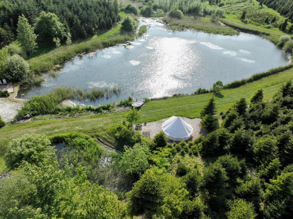 an aerial view of a lake with a tent at Calm and idyllic surroundings in Northen Jutland in Nibe