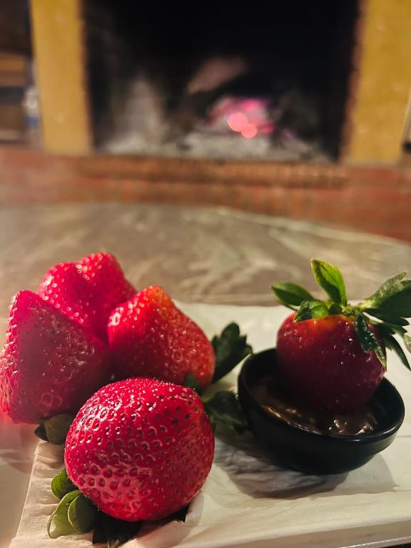 three strawberries on a plate on a table at maison d'hôtes yamine in Beni Mellal
