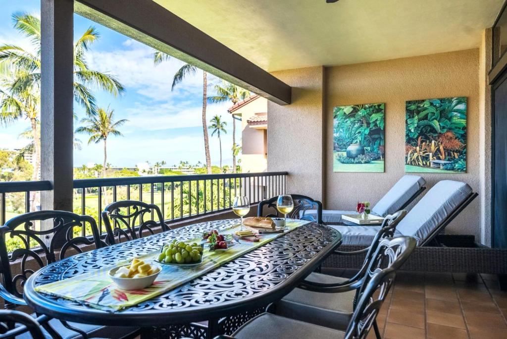a table and chairs on a balcony with food on it at KBM Resorts KRO-K302 2B Villa with free Rental car in Kaanapali