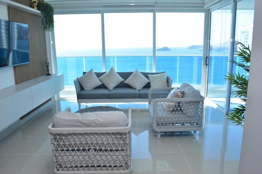 a living room with a couch and two chairs at Luxury Aparment in Reserva del Mar in Gaira