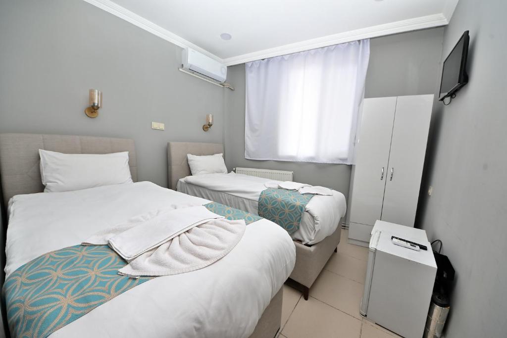 Postel nebo postele na pokoji v ubytování GRAND Deniz Hotel