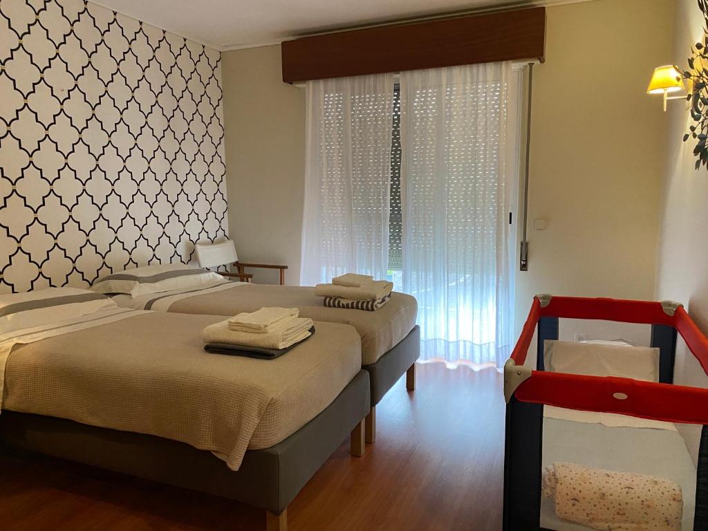 a bedroom with two beds and a window at Central House in Ponta Delgada