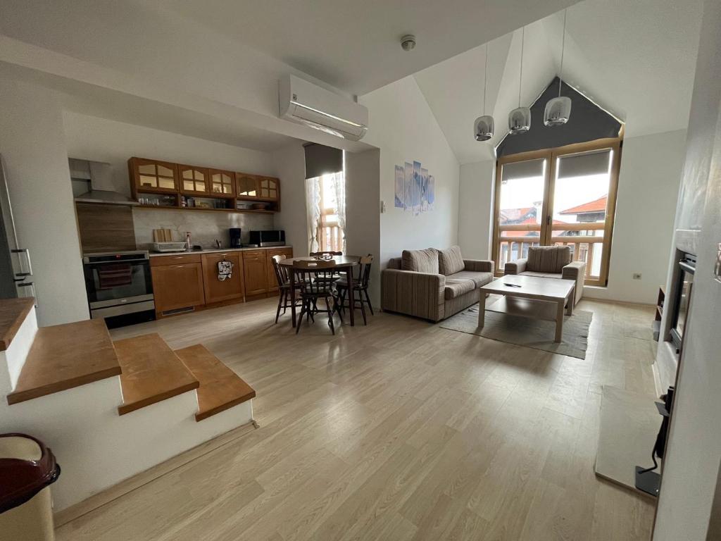 a living room with a couch and a table at Penthouse Harriet Bansko in Bansko