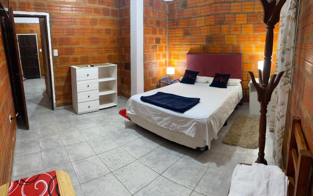 a bedroom with a bed and a dresser in a room at Departamento temporario ROSARIO in Formosa