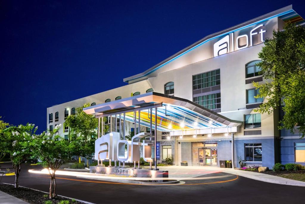 an office building with a lit up entrance at night at Aloft Columbia Harbison in Columbia