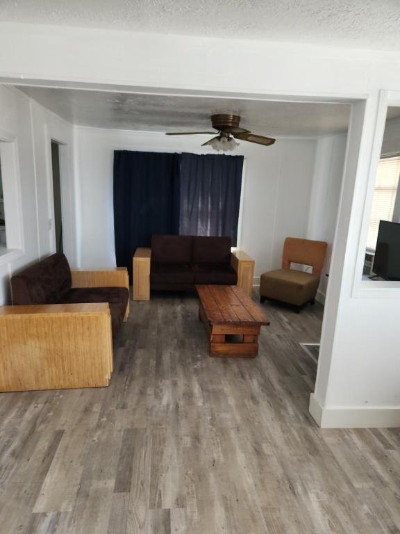 a living room with two couches and a table at 7 Beachside inn in Hampton