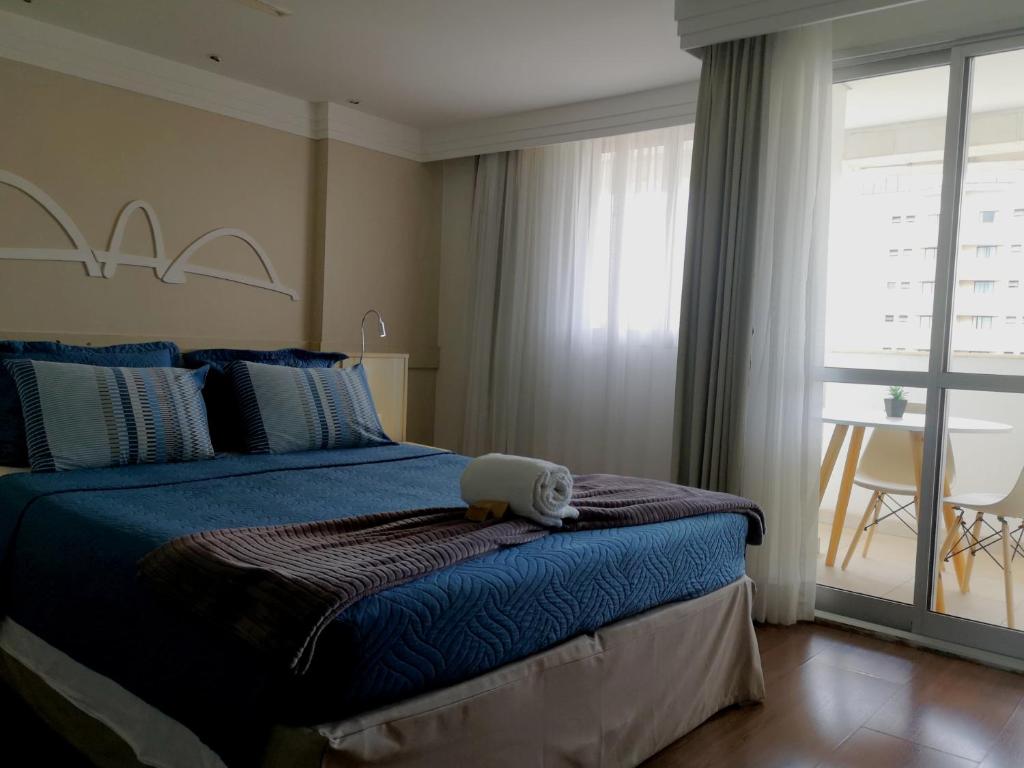 a bedroom with a bed with a stuffed animal on it at Flat particular no Hotel Mercure in Brasília