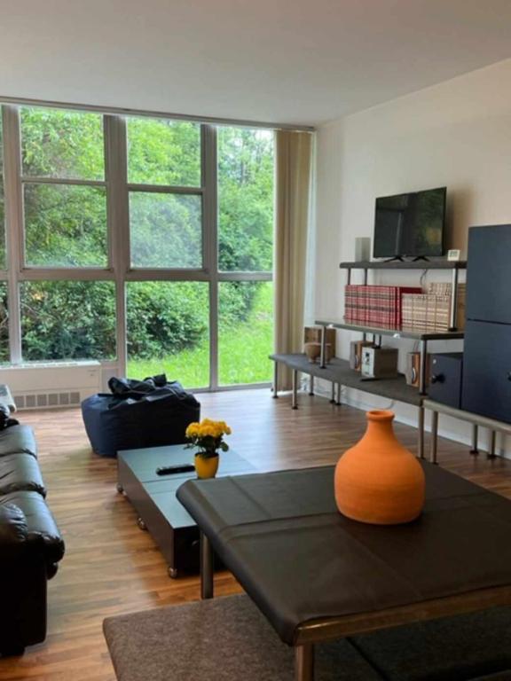 a living room with an orange vase on a coffee table at Talponia 212 in Ivrea