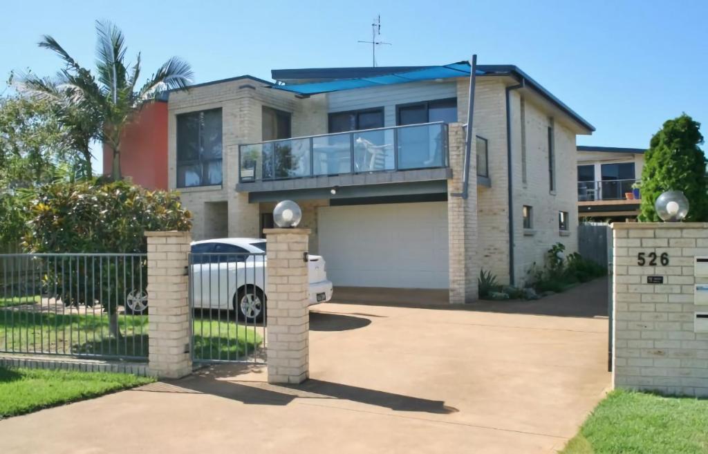 a house with a gate and a driveway at 526 Arthur Kaine Dr Merimbula in Merimbula