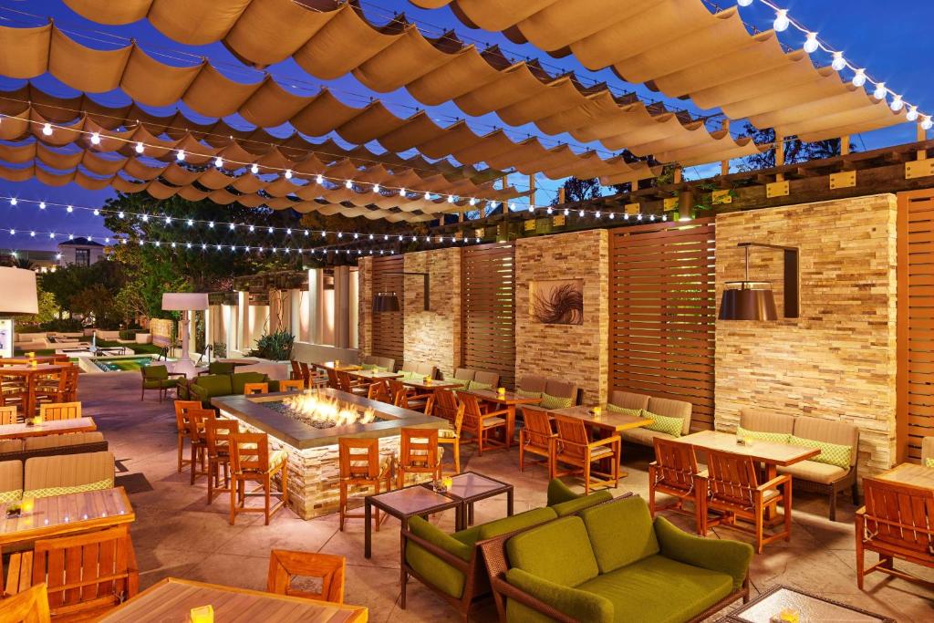 an outdoor restaurant with tables and chairs and lights at The Westin Pasadena in Pasadena