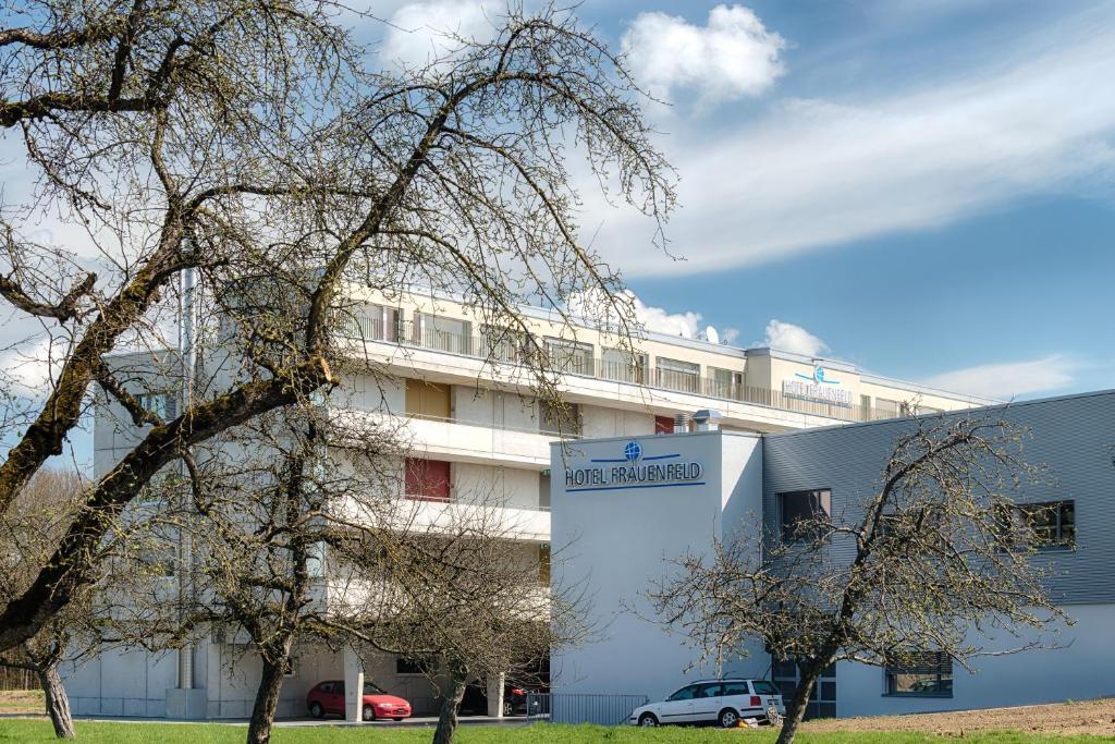 ein weißes Gebäude mit einem Schild davor in der Unterkunft Hotel Frauenfeld in Frauenfeld