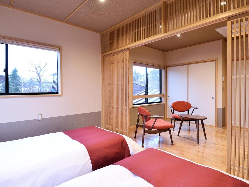 Postel nebo postele na pokoji v ubytování Ryokan Okayama