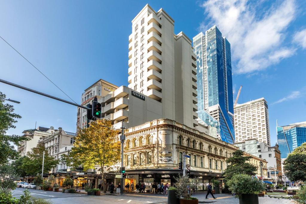 a building on a city street with tall buildings at Quest on Queen Serviced Apartments in Auckland