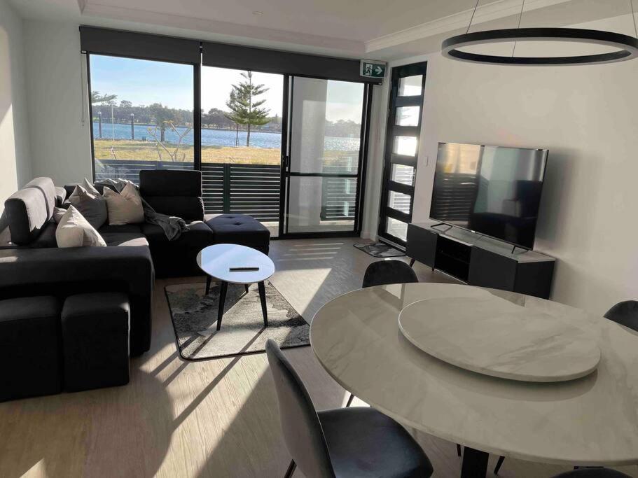 a living room with a couch and a table at New ground floor 2 bed/2 bath Apartment Marina in Mandurah