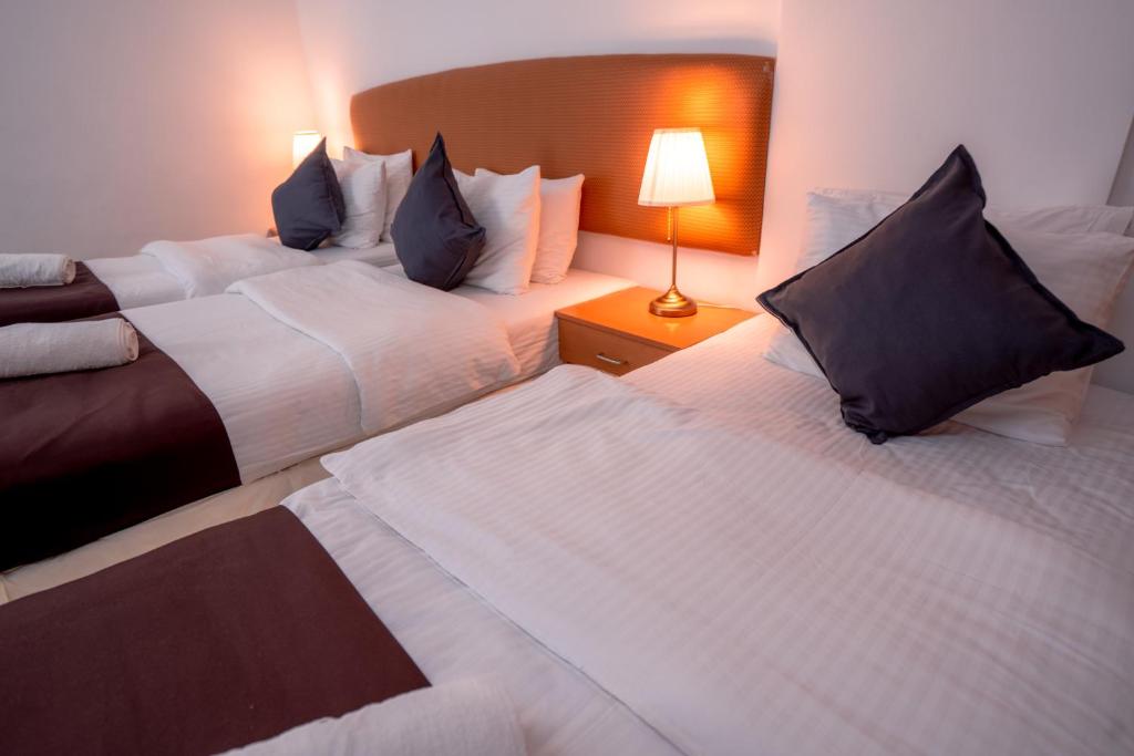 Postel nebo postele na pokoji v ubytování العاصمة للشقق الفندقية - Capital Hotel Apartments