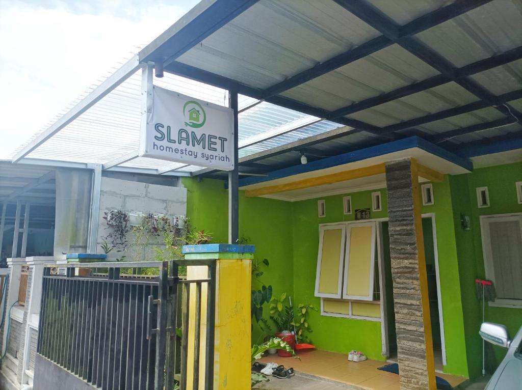 a building with awning and a sign in front of it at SLAMET HOMESTAY TASIKMALAYA in Tasikmalaya