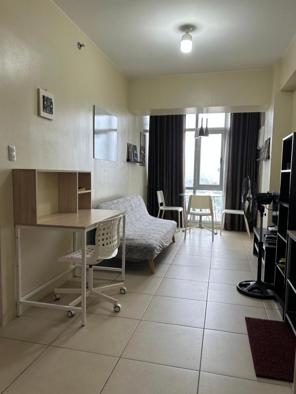 a hospital room with a bed and a desk at Fully furnished 1 BR Condo unit in Manila