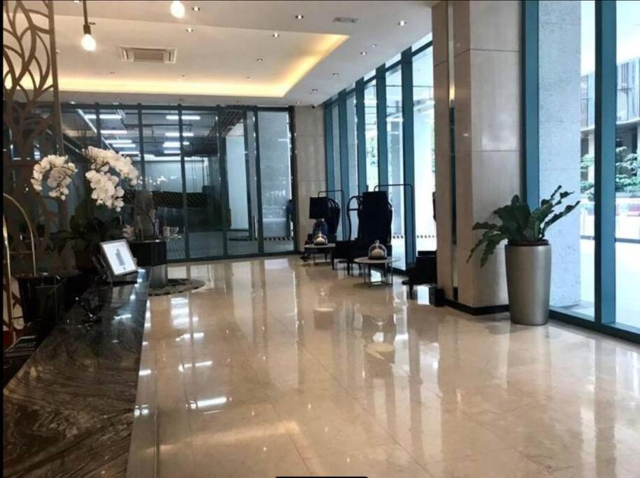 a lobby of a building with a hallway with windows at One Uptown Residence Prime Loc BGC,Uptown Linked 1BR,Washer,200mbps in Manila