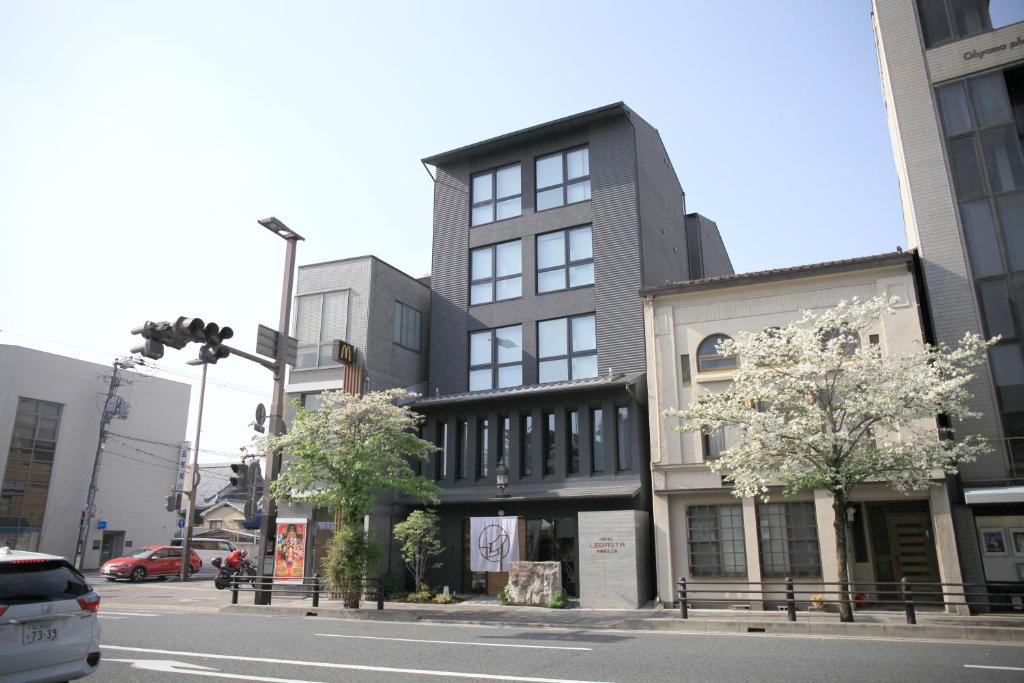 a building on the corner of a city street at Hotel Legasta Kyoto Higashiyama Sanjo in Kyoto