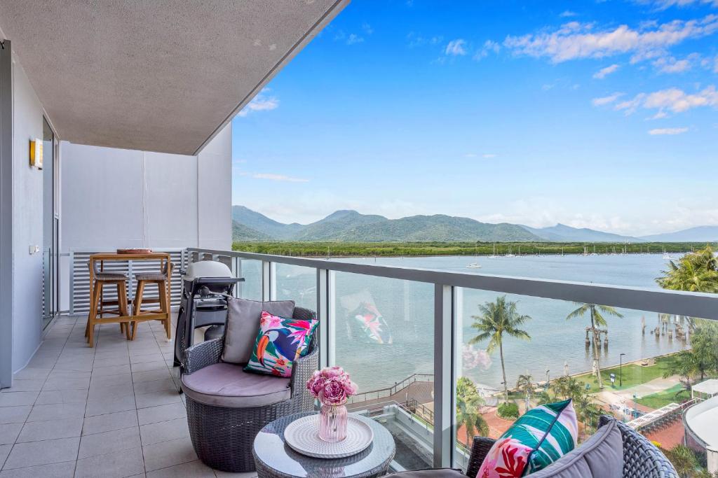a balcony with a view of the ocean at 2BR Stylish Getaway @ Harbour Lights Cairns in Cairns