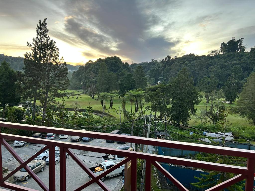 a balcony with cars parked in a parking lot at Cameron Iris AiSHomestay in Tanah Rata