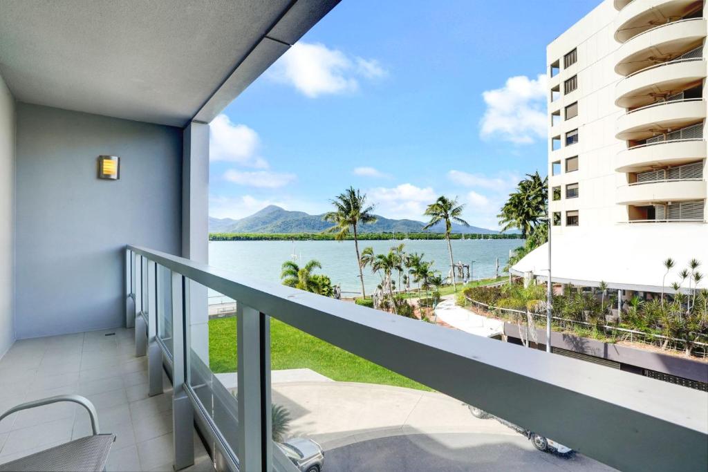 a balcony with a view of the water at 315 Harbour With Ocean Views in Cairns