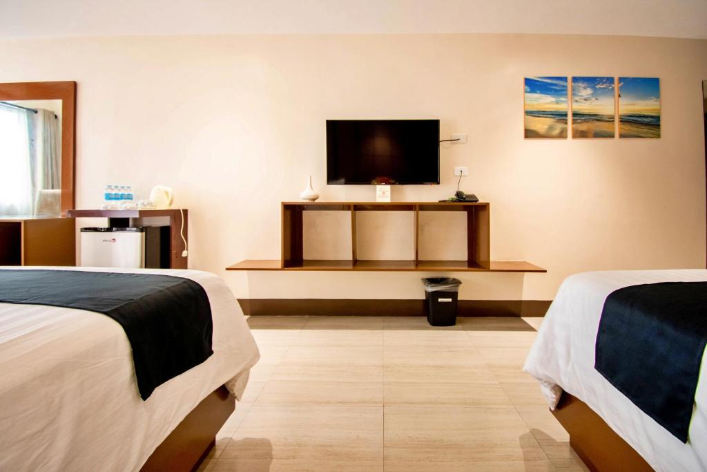 Postel nebo postele na pokoji v ubytování ECL Resort Hotel Boracay