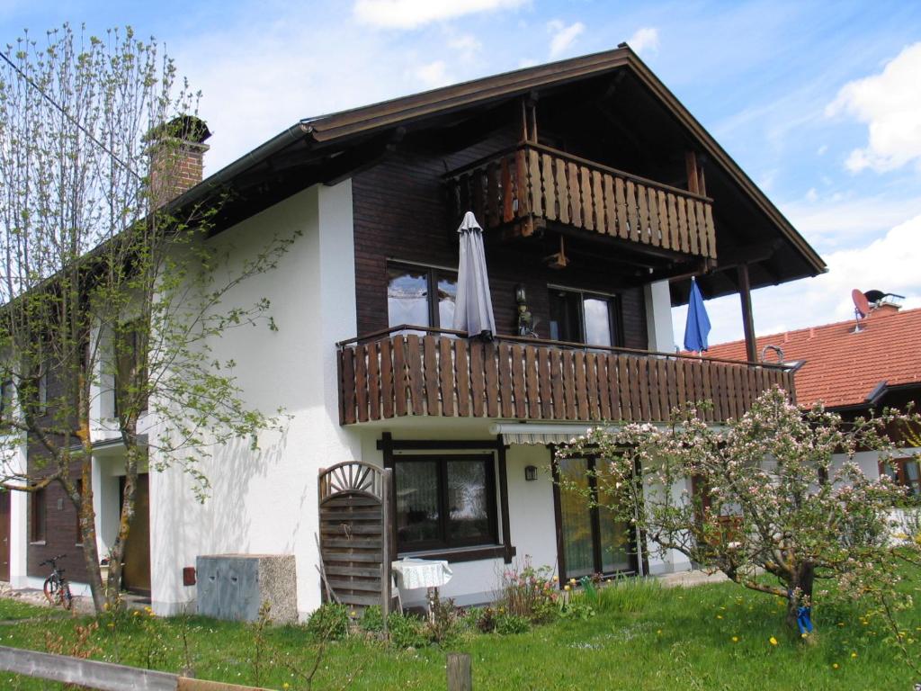 a house with a balcony on top of it at Ferienhaus Lang in Lechbruck