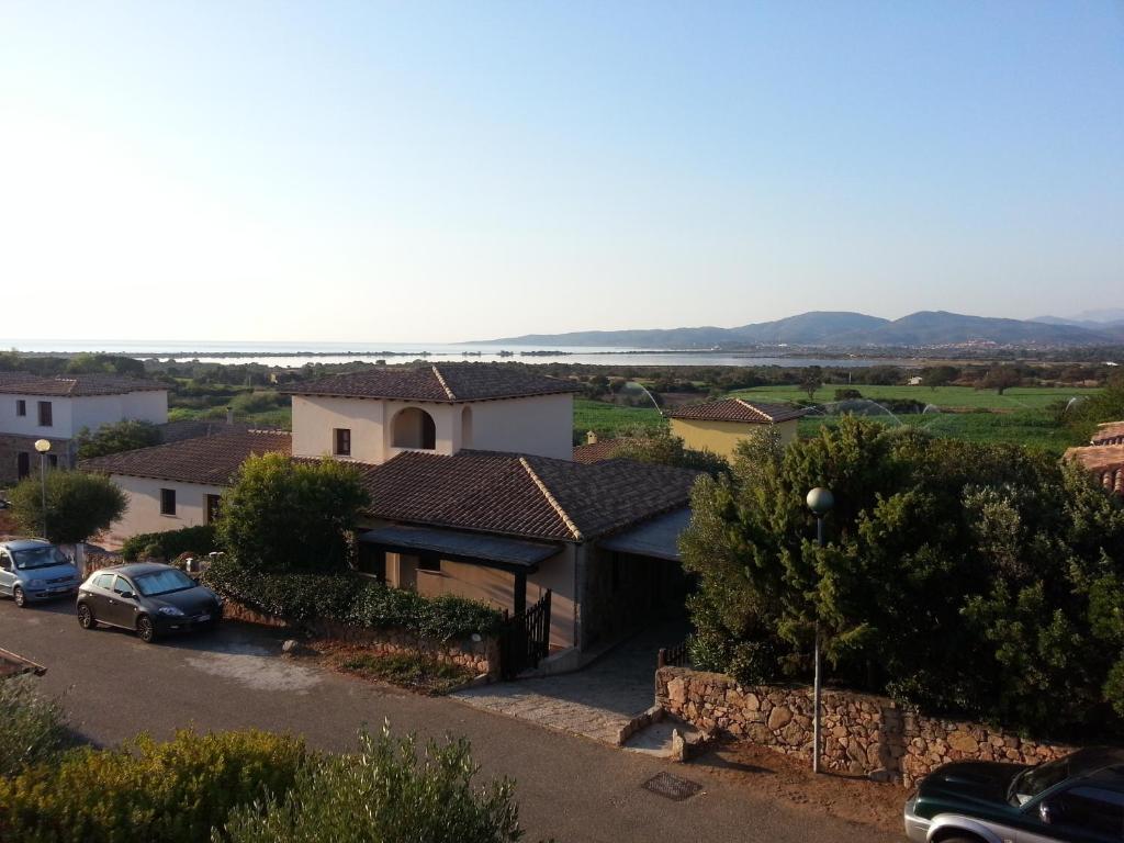 a house with a car parked in a parking lot at Da Teresa in San Teodoro