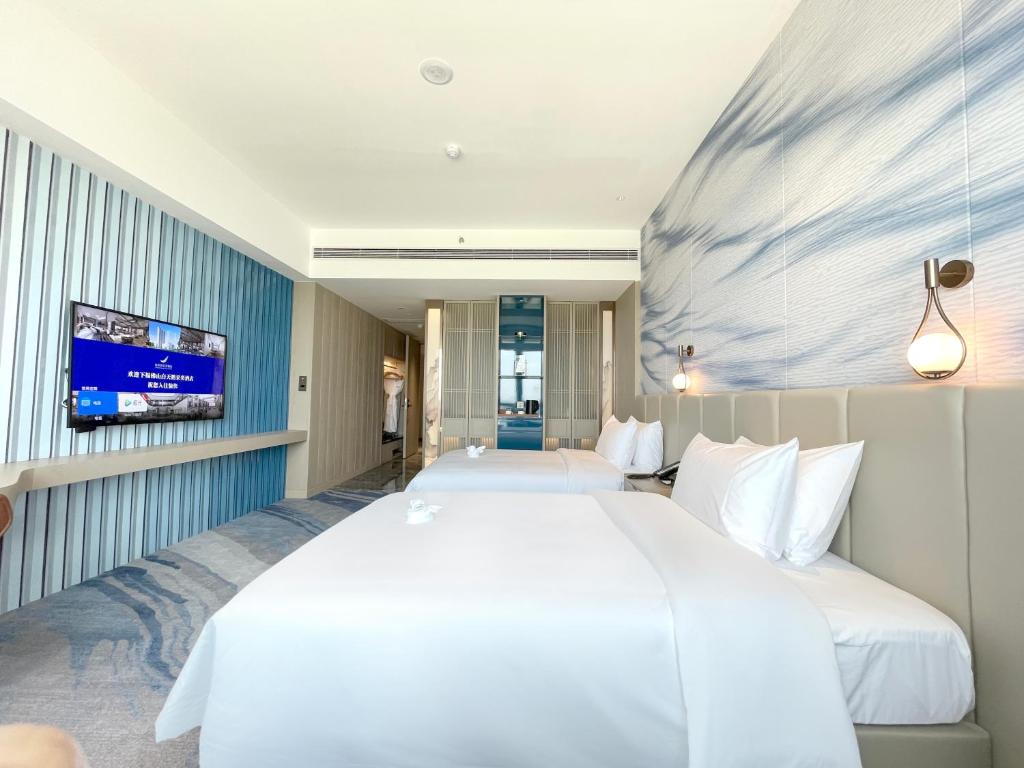 Postel nebo postele na pokoji v ubytování White Swan VYV Hotel, Foshan