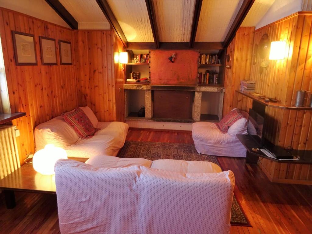 a living room with two couches and a table at Appartamento La Primula in Madesimo
