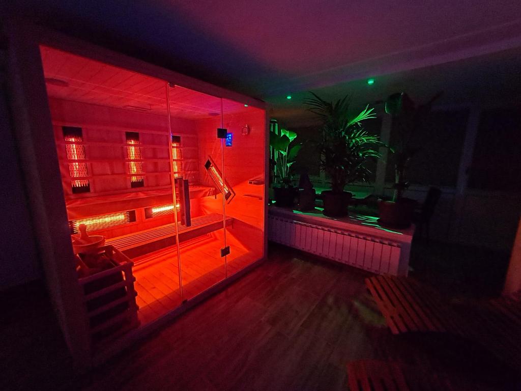 a dark room with a jukebox with red lights at Gottscheelux in Kočevje