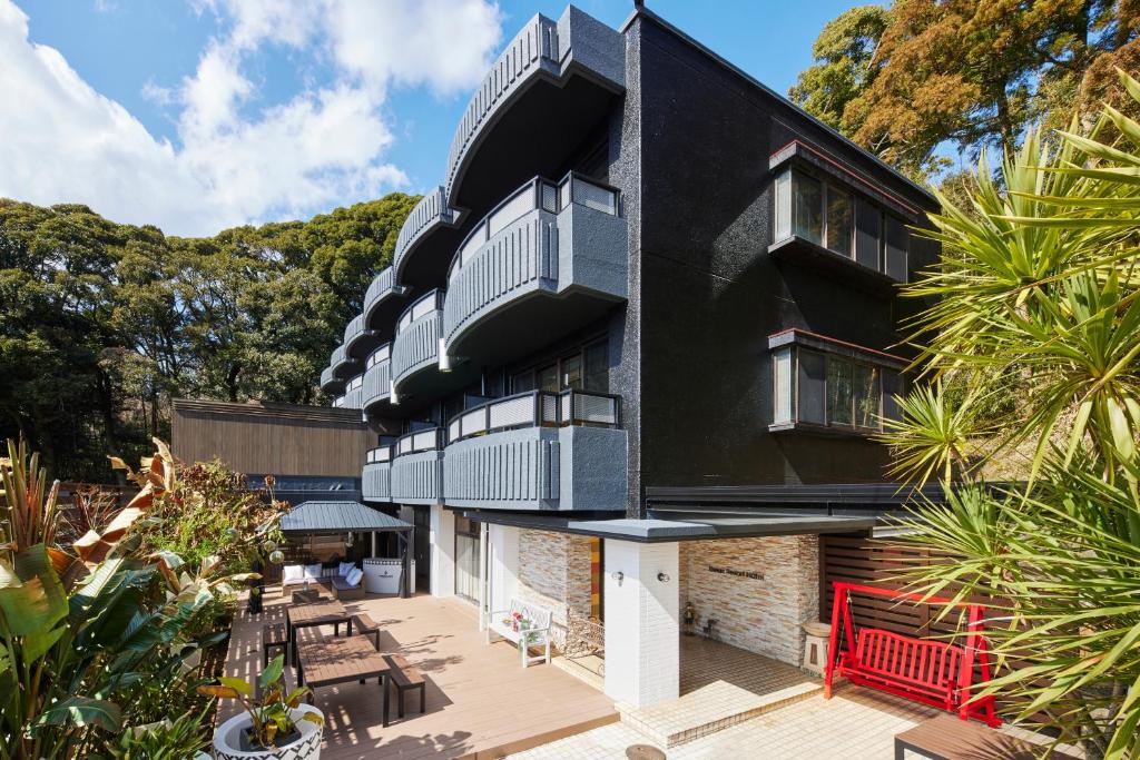 una vista exterior de una casa con una fachada negra en Relax Resort Hotel, en Atami