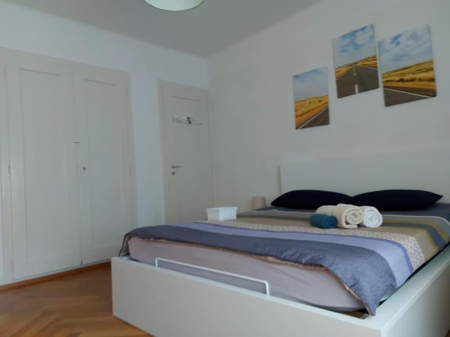 a bedroom with a bed with two towels on it at 4 minutes from Lausanne Train Station in Lausanne