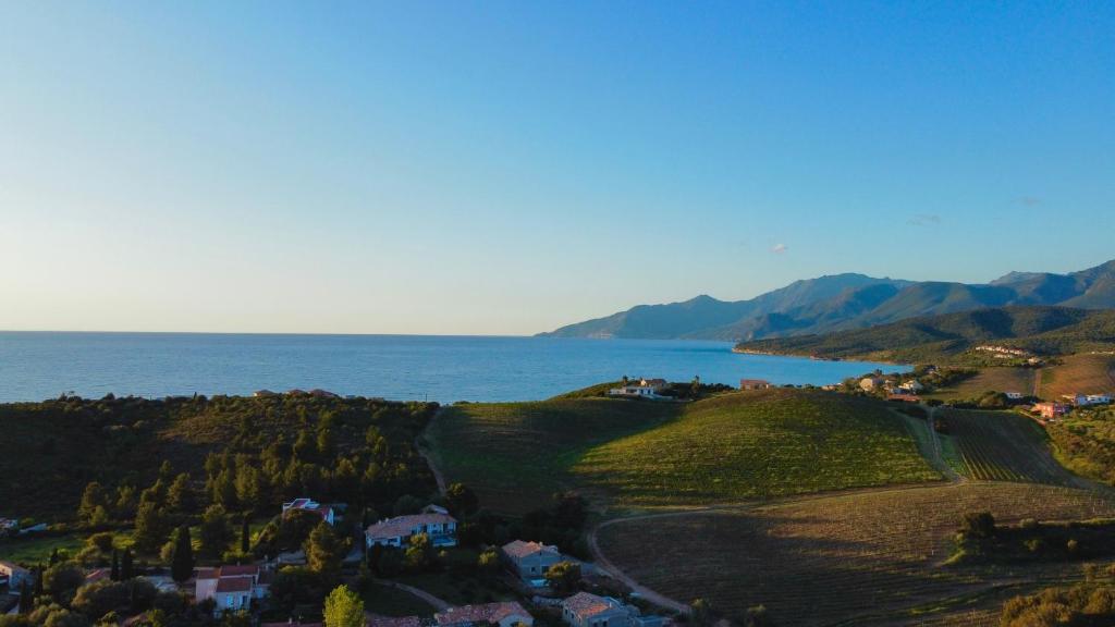 an aerial view of a town on a hill next to the ocean at Résidence CATALINA in Saint-Florent