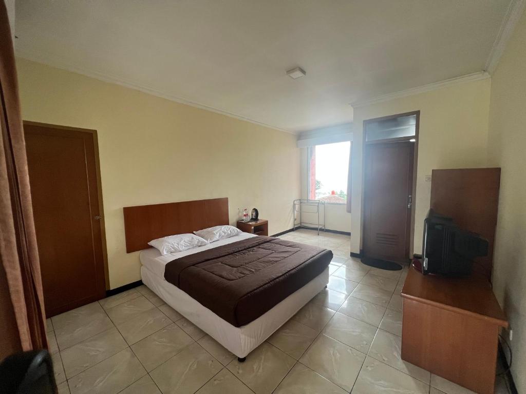Postel nebo postele na pokoji v ubytování Hotel Puspa Sari
