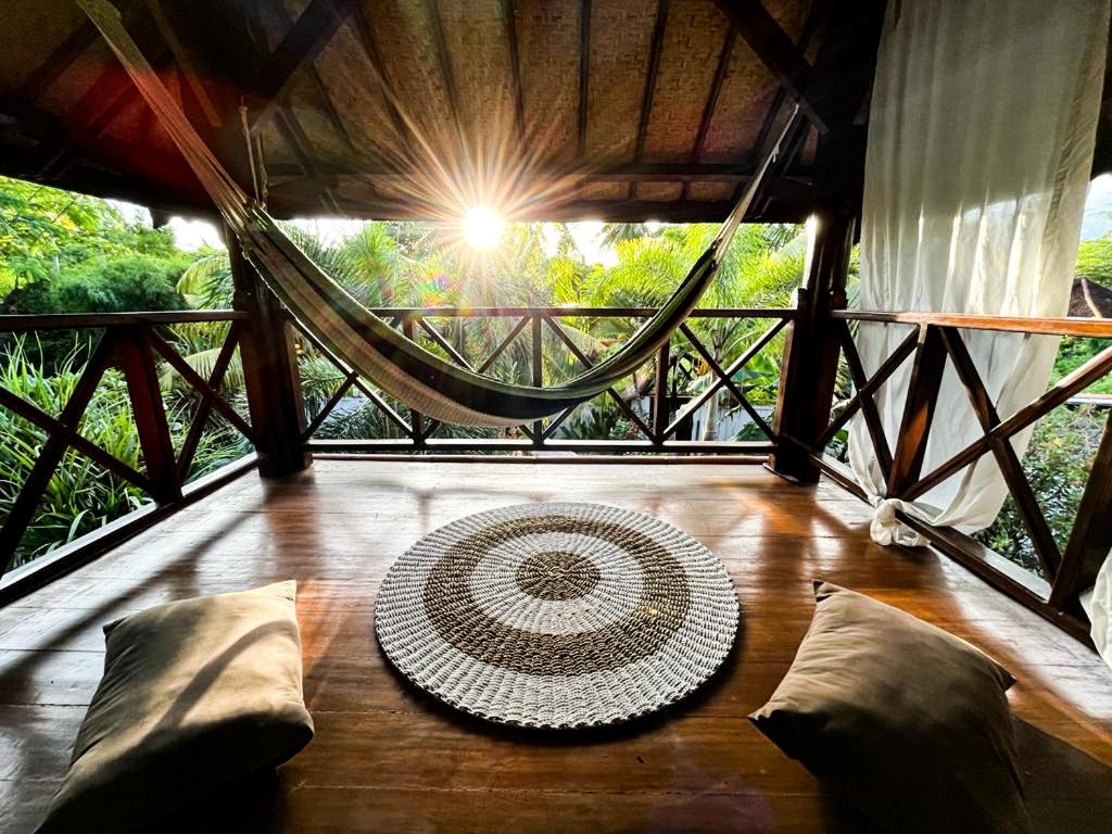 a room with a rug on a wooden floor at Gili Moonlight Retreat in Gili Air