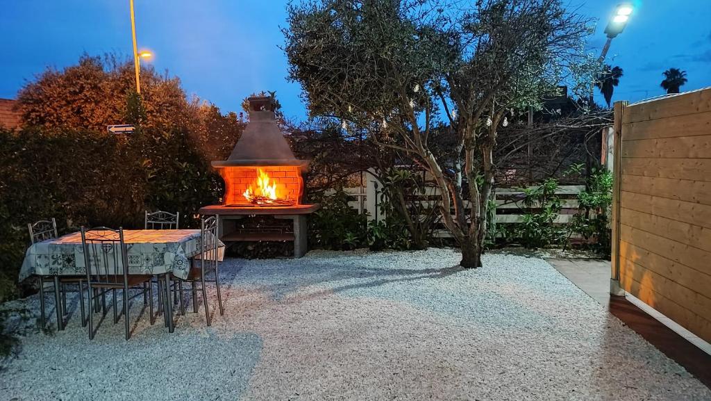 a table and chairs with a lantern in a garden at Casa vacanze M&M Tortolì in Tortolì