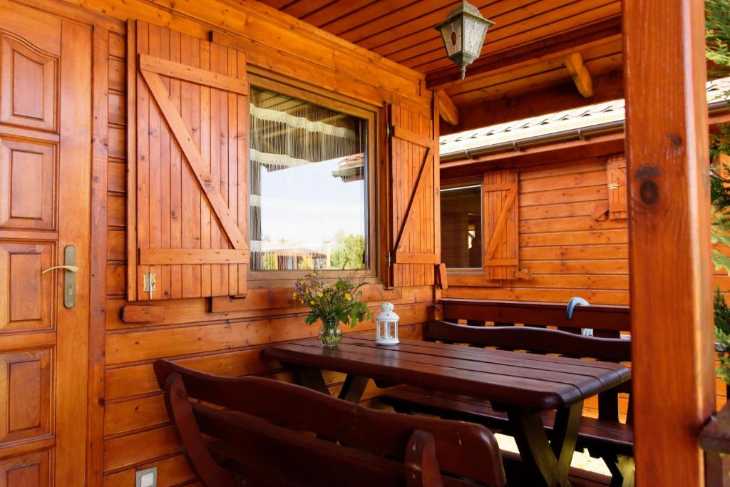 a wooden porch with a wooden table and chairs at SOLAR WICIE in Wicie