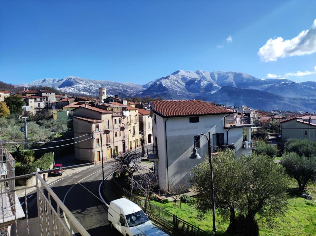 a white van parked on a street with mountains in the background at Casa Vacanze Gelbison in Moio della Civitella