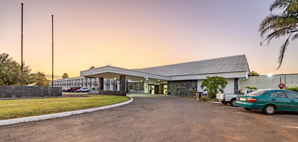 a building with a car parked in front of it at African Sky Newcastle Inn in Newcastle