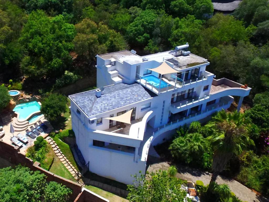 an aerial view of a house with a swimming pool at El Shadai Guest House & Spa Hartbeespoort in Hartbeespoort