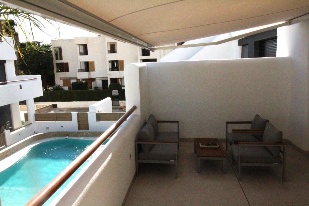 a balcony with chairs and a swimming pool on a building at Elvira Home San Gines AQ-104 in Santiago de la Ribera
