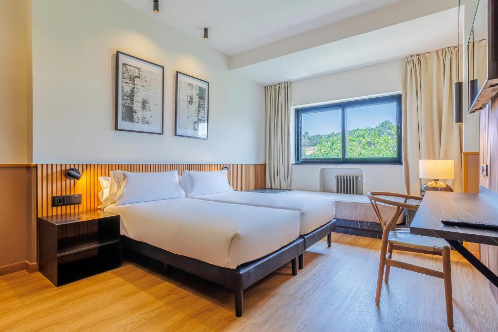 Tempat tidur dalam kamar di Hotel Acta Madfor