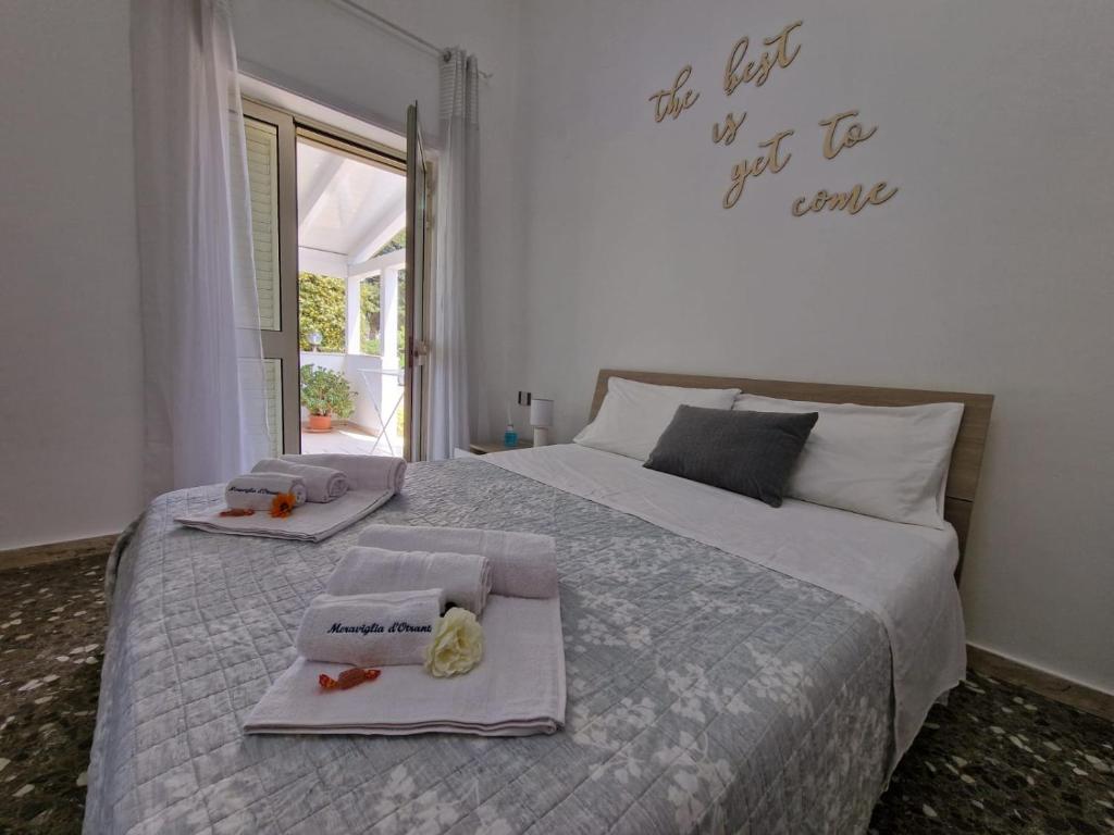 a bedroom with a bed with two towels on it at Meraviglia d'Otranto in Otranto