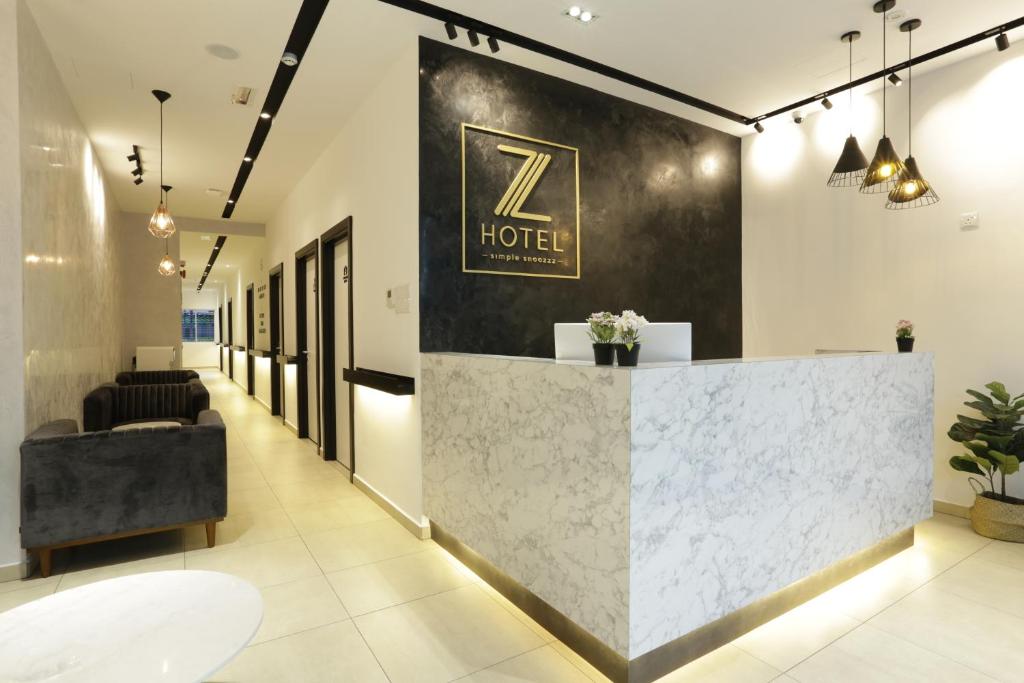 a lobby with a hotel sign on the wall at Z Hotel in Petaling Jaya