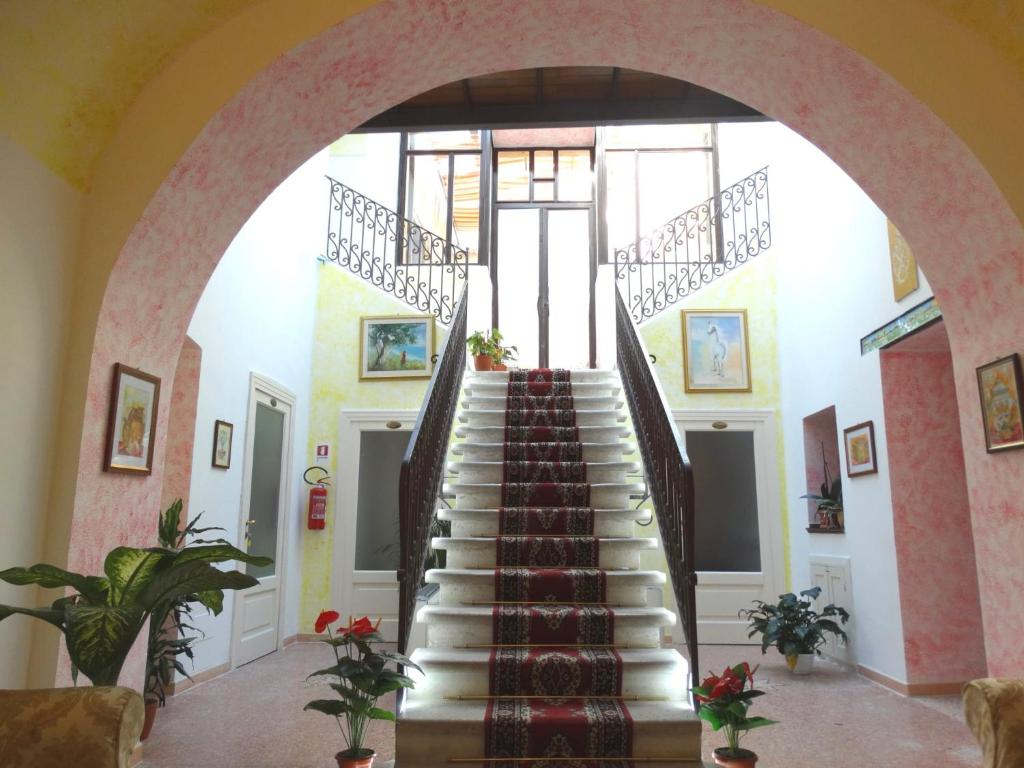 a staircase in a building with a stair case at Hotel San Giuseppe in Gerace