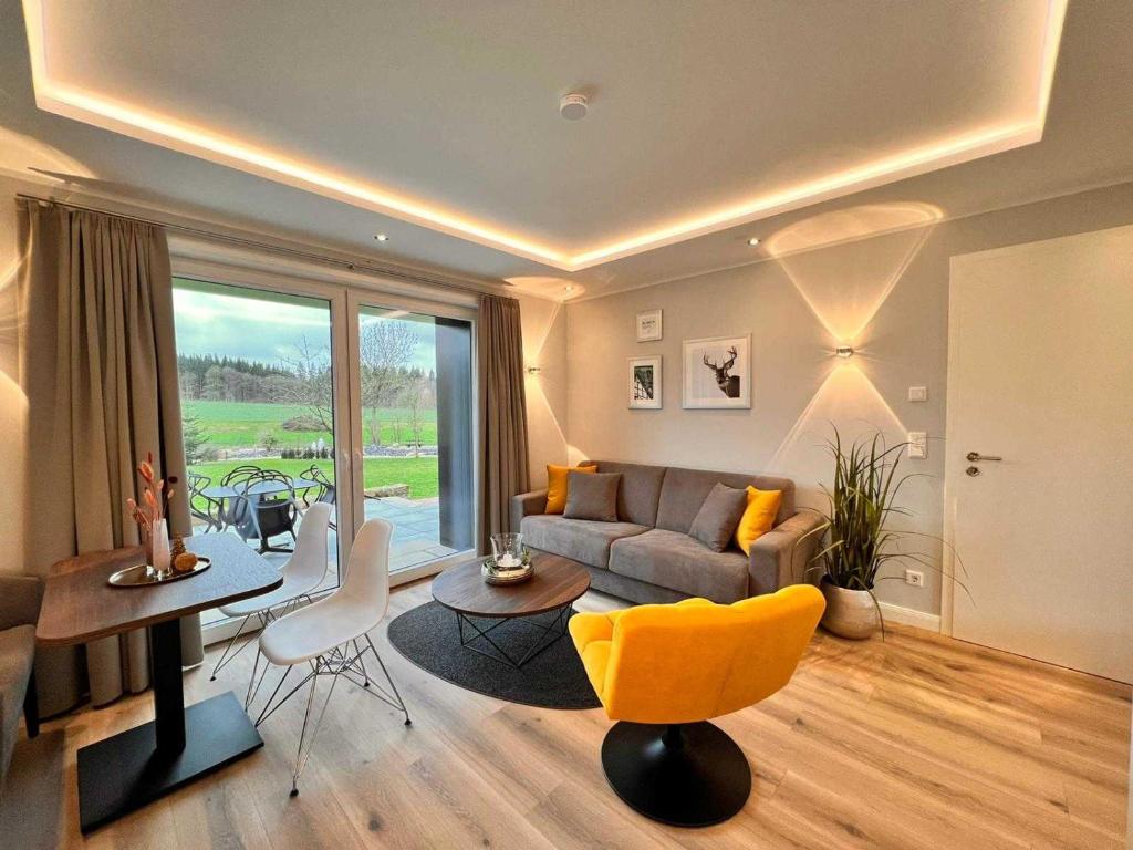 ein Wohnzimmer mit einem Sofa und einem Tisch in der Unterkunft DRIEHOF Lifestyle Comfort Apartment 3 in Tecklenburg